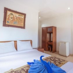 Elegant Deluxe Room bedroom at Ubud Homestay