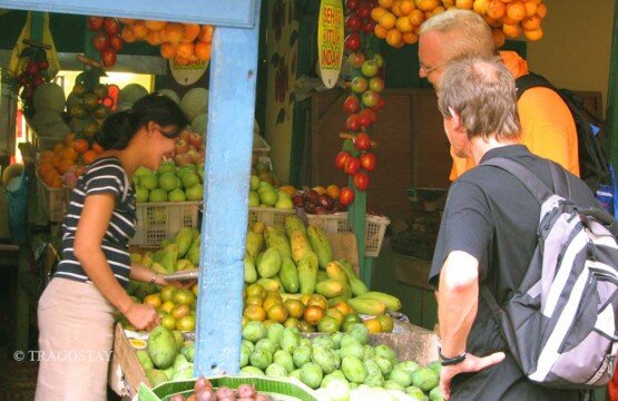Colorful tropical fruit stall at Badung Market featuring mangosteen, durian, and salak.