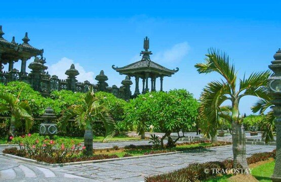 A detailed architectural photograph highlighting the grey volcanic stone carvings and the traditional Hindu-Balinese design elements of this iconic historical site.