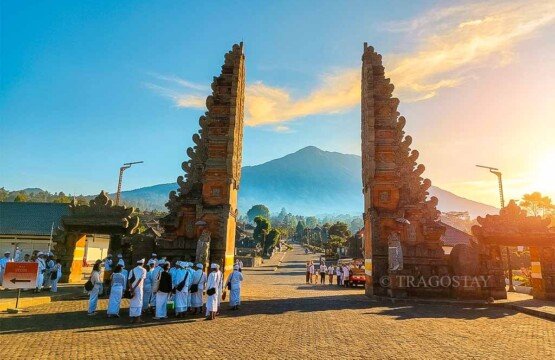 A towering Candi Bentar split gateway at Besakih Temple against a clear blue sky.