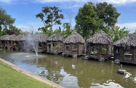 Large tropical fish pond at Big Garden Corner Bali with colorful koi fish.