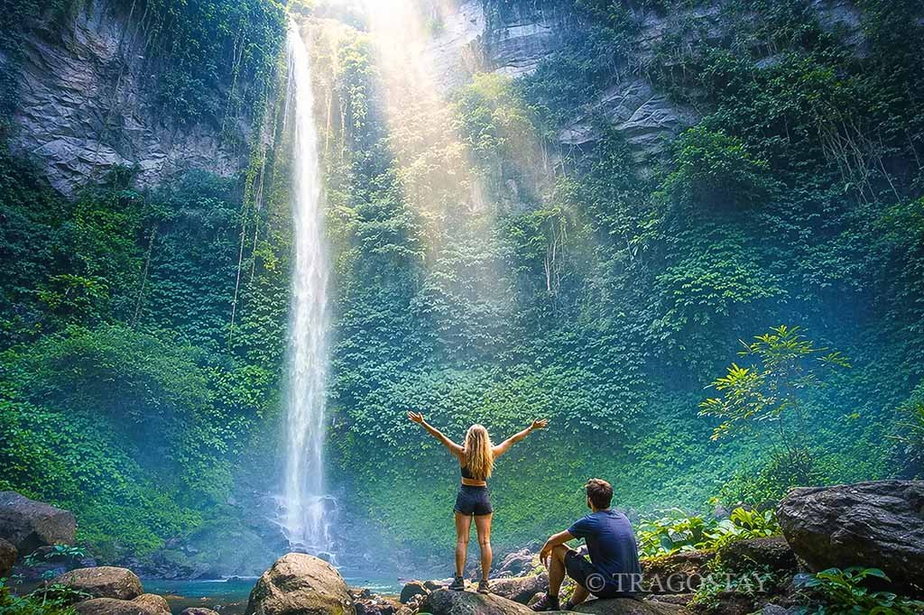 Visitors enjoying the cool and fresh atmosphere at the towering Blahmantung Waterfall.