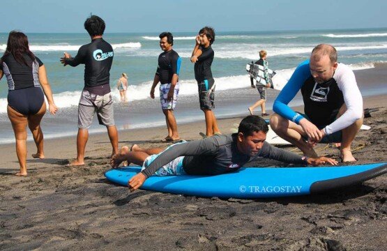 Beginner taking a Canggu Beach surf lesson to experience surfing in paradise.