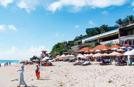 Experience fun activities at Dreamland Beach including swimming and sunbathing in Bali.