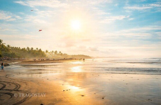 Traditional Balinese kite flying activity at Kelating Beach during the windy season.