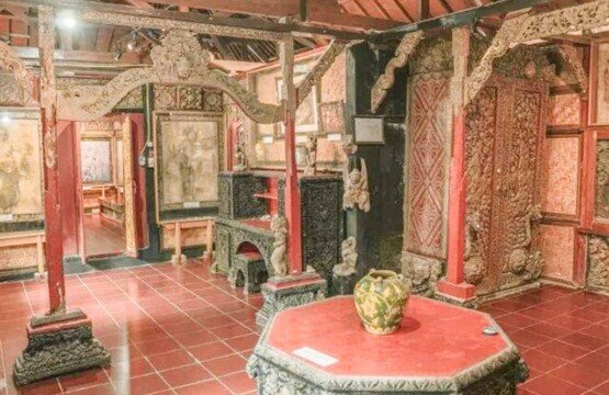 Traditional Balinese interior of the Le Mayeur Museum with carved wooden furniture.