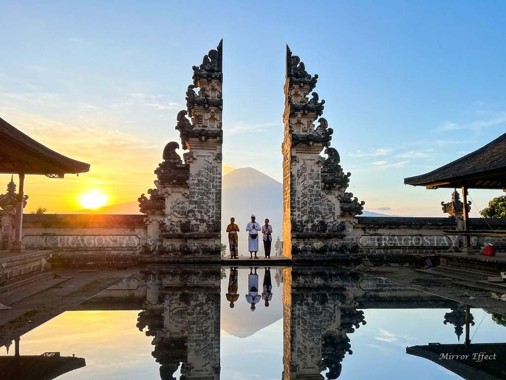 A scenic sunrise view through the Bali Gate of Heaven at Lempuyang Temple with Mount Agung in the distance.