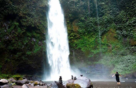 Refreshing Nungnung Waterfall pool at the base of the great fall for Bali adventures.
