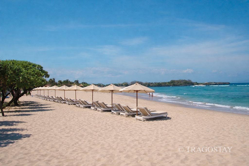 Matching color beach umbrellas at Nusa Dua Beach for a serene Bali relaxation experience.