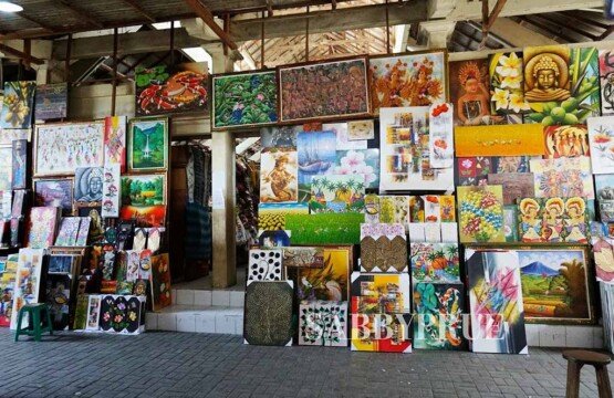 An overhead shot of neatly folded Batik sarongs, handmade soaps, and aromatic incense sticks, representing the rich sensory experience of shopping in Sukawati.