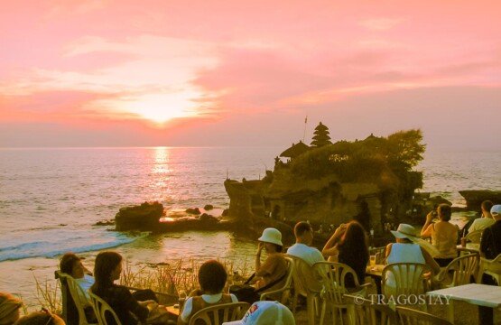 Spectacular sunset view at Tanah Lot Temple Bali with a vibrant orange sky.