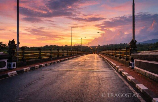 Tukad Bangkung Bridge sunset with orange sky at popular Bali tourist destinations.