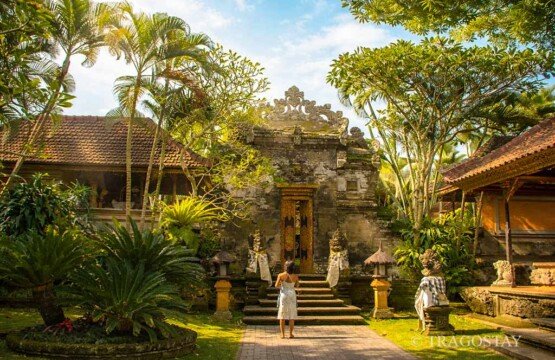 The grand entrance gate of the main area at Ubud Royal Palace Puri Saren with intricate Balinese stone carvings.