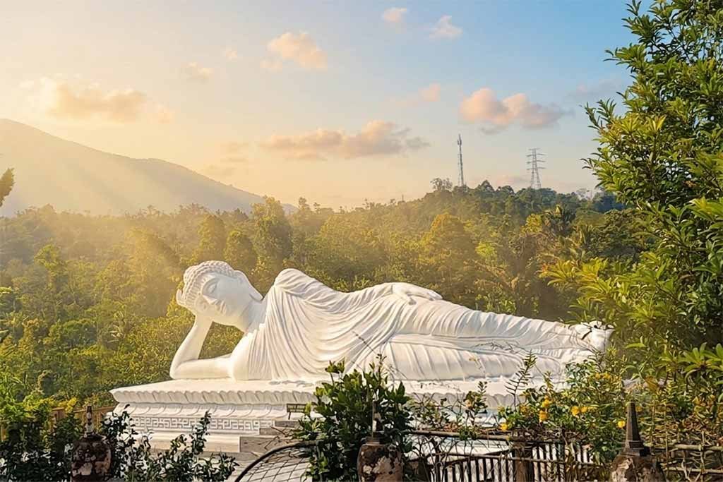 The golden glow of the afternoon sun hitting the Sleeping Buddha at Vihara Dharma Giri.