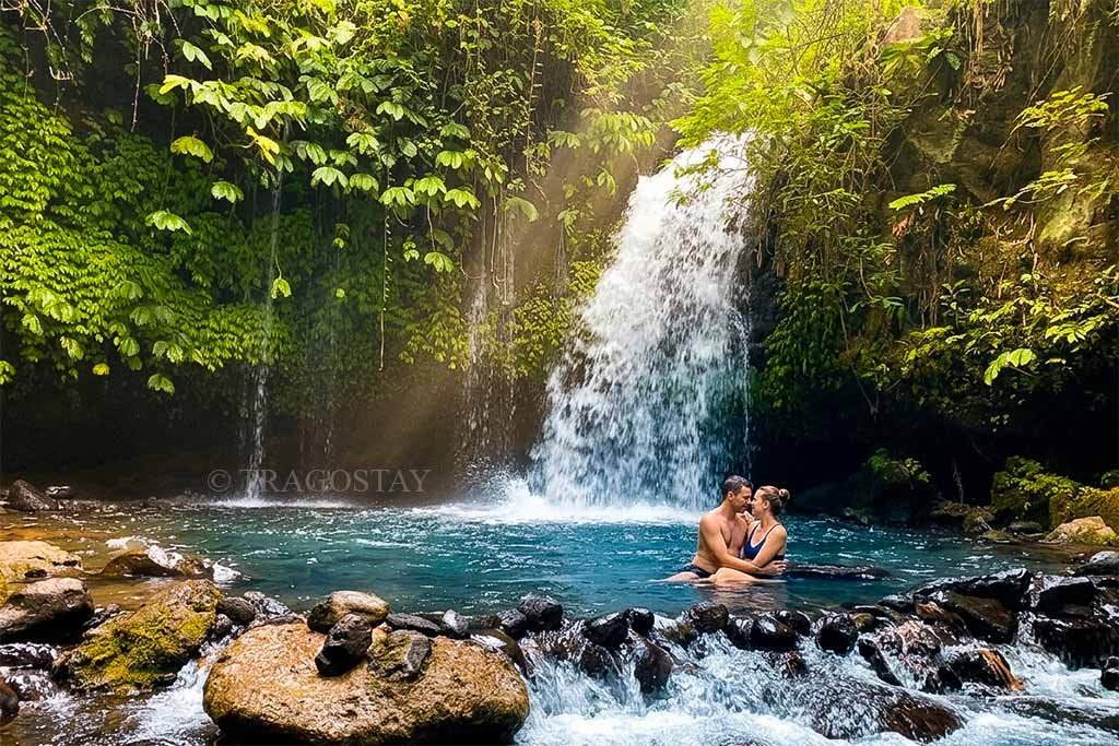A couple enjoying a romantic nuance at the peaceful Yeh Hoo Waterfall Jatiluwih.