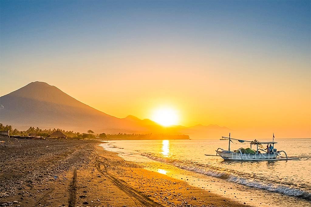 A stunning and peaceful sunrise over the calm horizon of Amed Beach in East Bali.