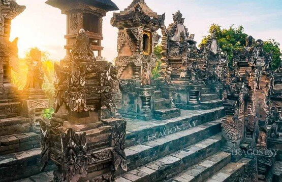 Several ancient stone shrines inside Beji Temple, displaying the highly expressive and classic northern style of Balinese temple carving.