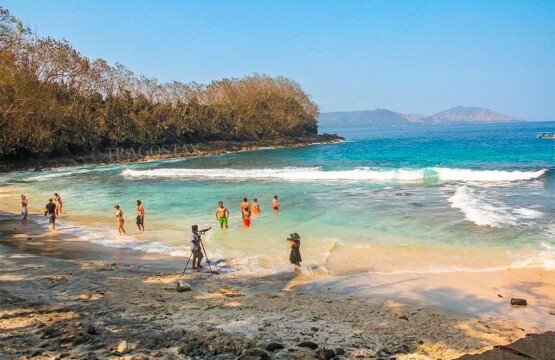 Visitors participating in fun beach activities like snorkeling and sunbathing at Blue Lagoon Beach Padangbai.