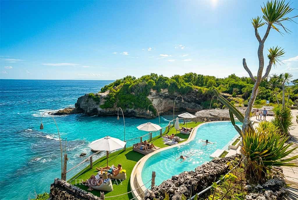 An overview of a designer swimming pool on a cliff with tourists enjoying their holiday at Blue Lagoon.