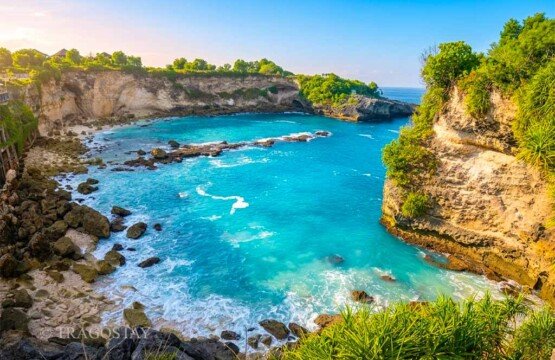 The rugged white limestone cliffs of Blue Lagoon illuminated by the clear morning sunlight.