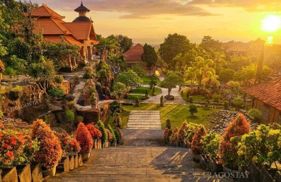 A scenic hilltop overview looking out across lush green trees toward the blue ocean horizon from Brahmavihara Arama.