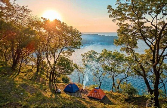 Tents pitched at Bukit Asah Bugbug during a fresh and vibrant morning sunrise.