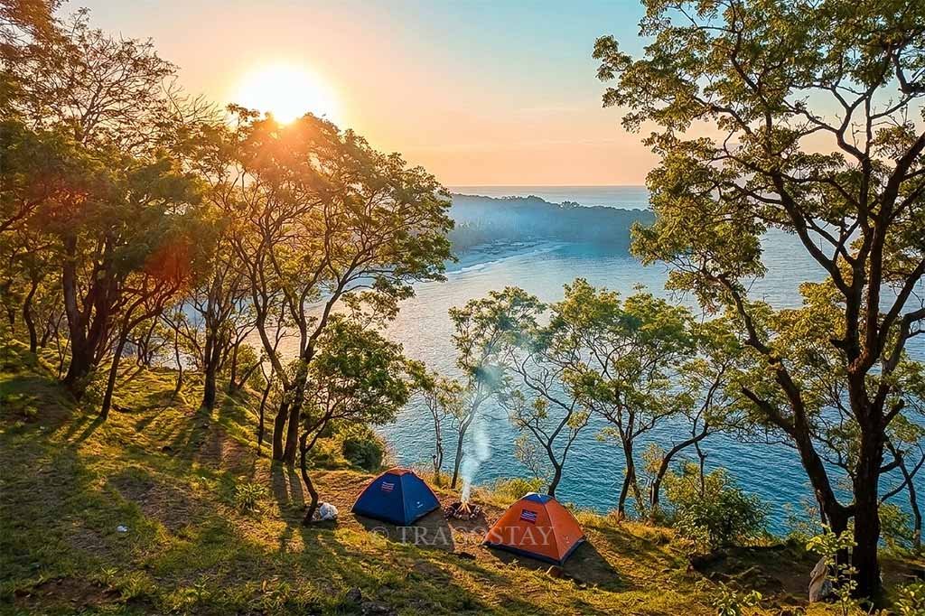 Tents pitched at Bukit Asah Bugbug during a fresh and vibrant morning sunrise.