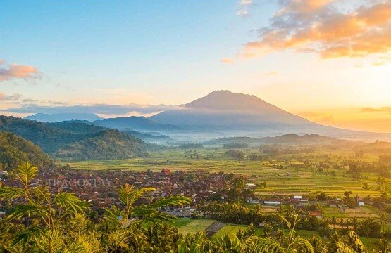 A scenic overview of Bugbug Village from Bukit Asah with a majestic mountain standing in the background.