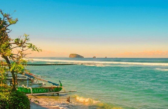 A scenic view of Gili Mempang islands seen from Candidasa Beach during a clear morning.