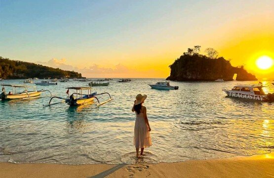 A woman posing at the edge of the water during a clear and bright sunset at Crystal Bay beach.