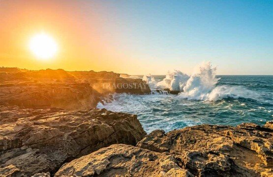 The bright morning sun illuminating the giant ocean swells and misty spray at Devil’s Tears Nusa Lembongan.