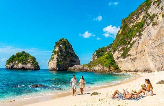 International tourists relaxing on the pristine shore and enjoying the natural scenery of Diamond Beach.