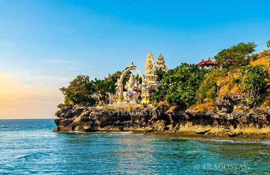 A close-up view of the giant white Lord Ganesha statue sitting majestically and facing the ocean at Menjangan Island.