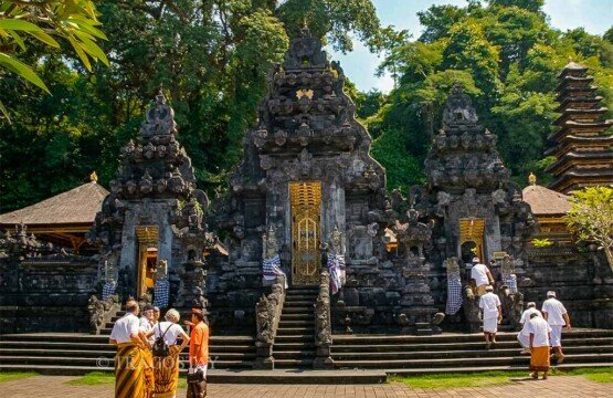 The grand entrance gate of Goa Lawah Temple meticulously crafted from black volcanic stone.