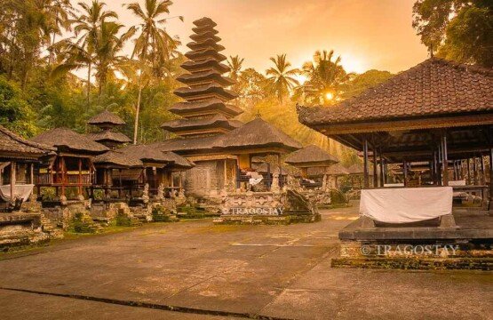 The grand architecture and multi-tiered shrines inside the main sanctuary of Kehen Temple during a sunny afternoon.