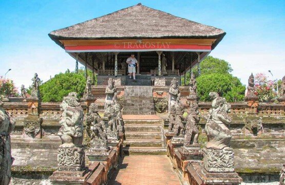 The stone pathway leading to Bale Kambang at Kerta Gosa lined with ornate traditional Balinese paras statues.