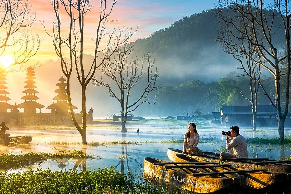 The stunning beauty of Lake Tamblingan on a clear morning with the sacred Pura Ulun Danu Tamblingan standing gracefully in the background.