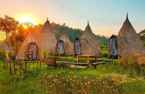 The peaceful and scenic atmosphere of Maha Gangga Valley accommodation structures during sunset.