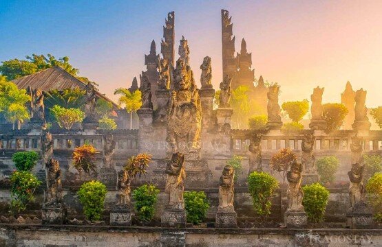The impressive and iconic stone boundary wall of Meduwe Karang Temple, decorated with a long row of beautifully carved traditional Balinese statues.