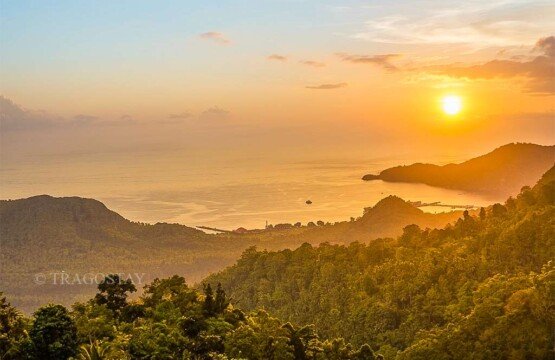 The vibrant orange and purple sky during a spectacular sunset captured from the peak of Putung Hill.