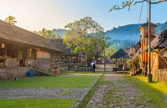 The quiet and serene atmosphere of Tenganan Pegringsingan Village streets during the late afternoon hours.
